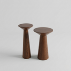 Two wooden stools on a light gray background