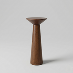 Wooden vase with a wide base and narrow top on a light gray background