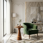 Modern living room with a green armchair, wooden side table, and marble wall.
