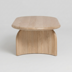 modern sculptural wooden coffee table with curved base in luxury living room interior in jodhpur