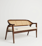 Wooden bench with wicker backrest and white cushion on a light gray background