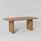 Sculpted solid wood dining table with rounded pedestal legs