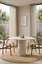 Round white marble dining table with fluted pedestal base