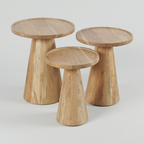 Three wooden side tables with a natural finish on a light gray background