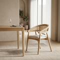 Wooden dining table with a chair in a bright room with large windows.