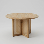 Round wooden dining table with cane pedestal base