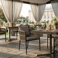 Outdoor dining area with wooden tables, chairs, and decorative elements on a stone patio.
